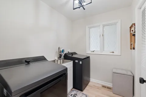 a bedroom with furniture and a large window