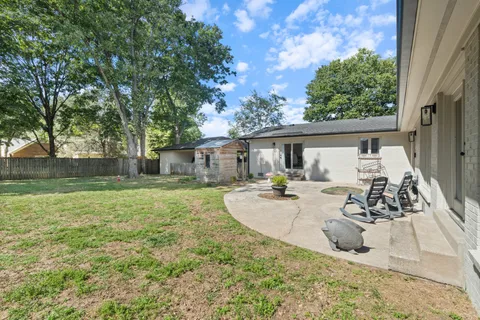 an aerial view of a house with a yard basket ball court and outdoor seating