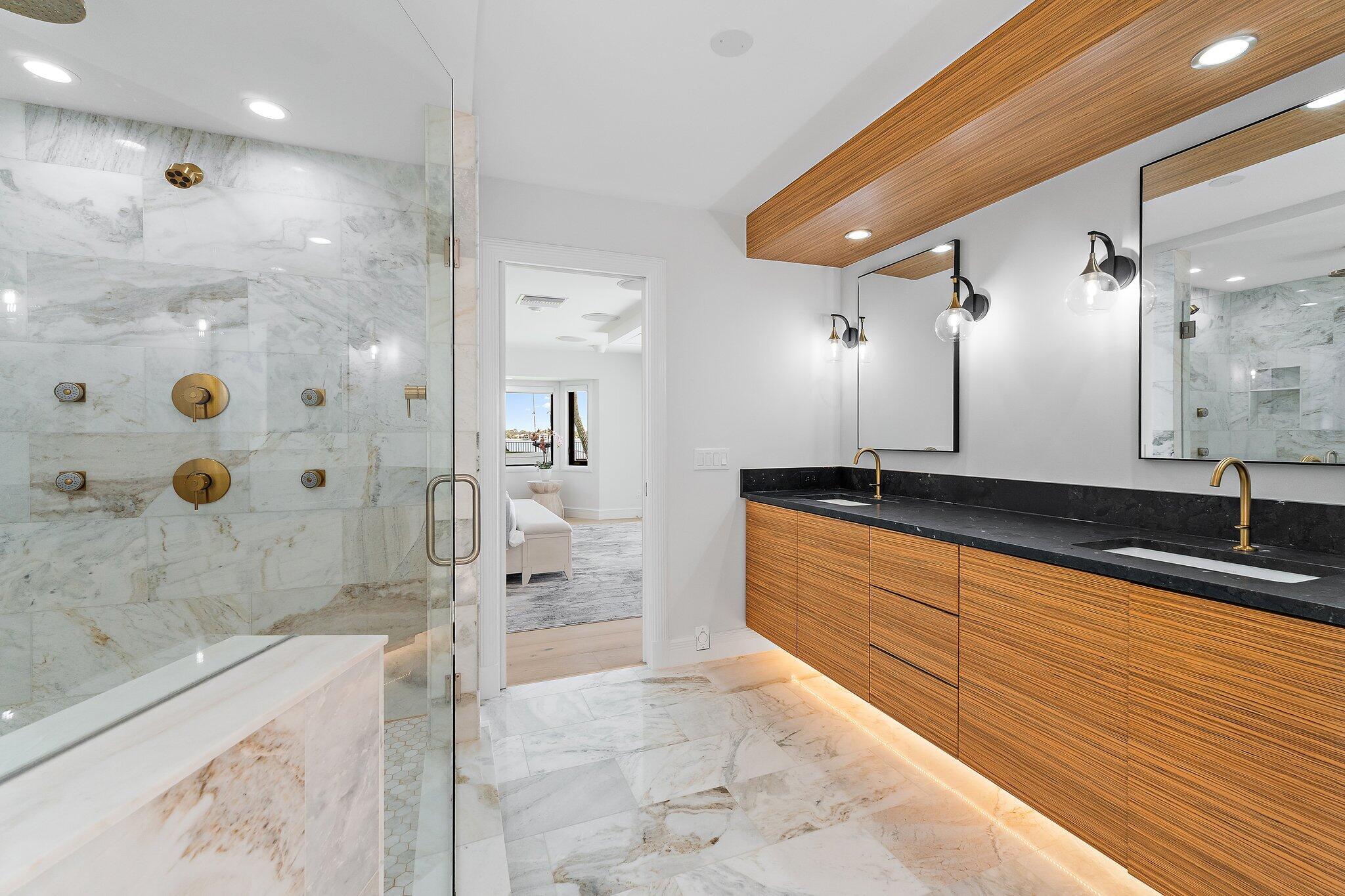 9 North River Road Stuart, FL 34996 - Photo 11 of 24 a large spacious bathroom with a granite countertop sink a toilet a mirror and shower