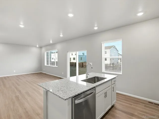 a kitchen with granite countertop a sink and a window