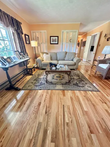 a living room with furniture and a chandelier
