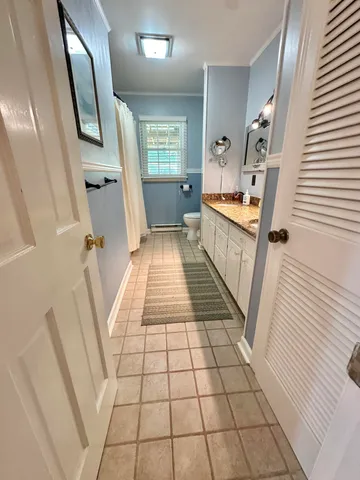 a view of a big yard with table and chairs and a fire pit with wooden fence