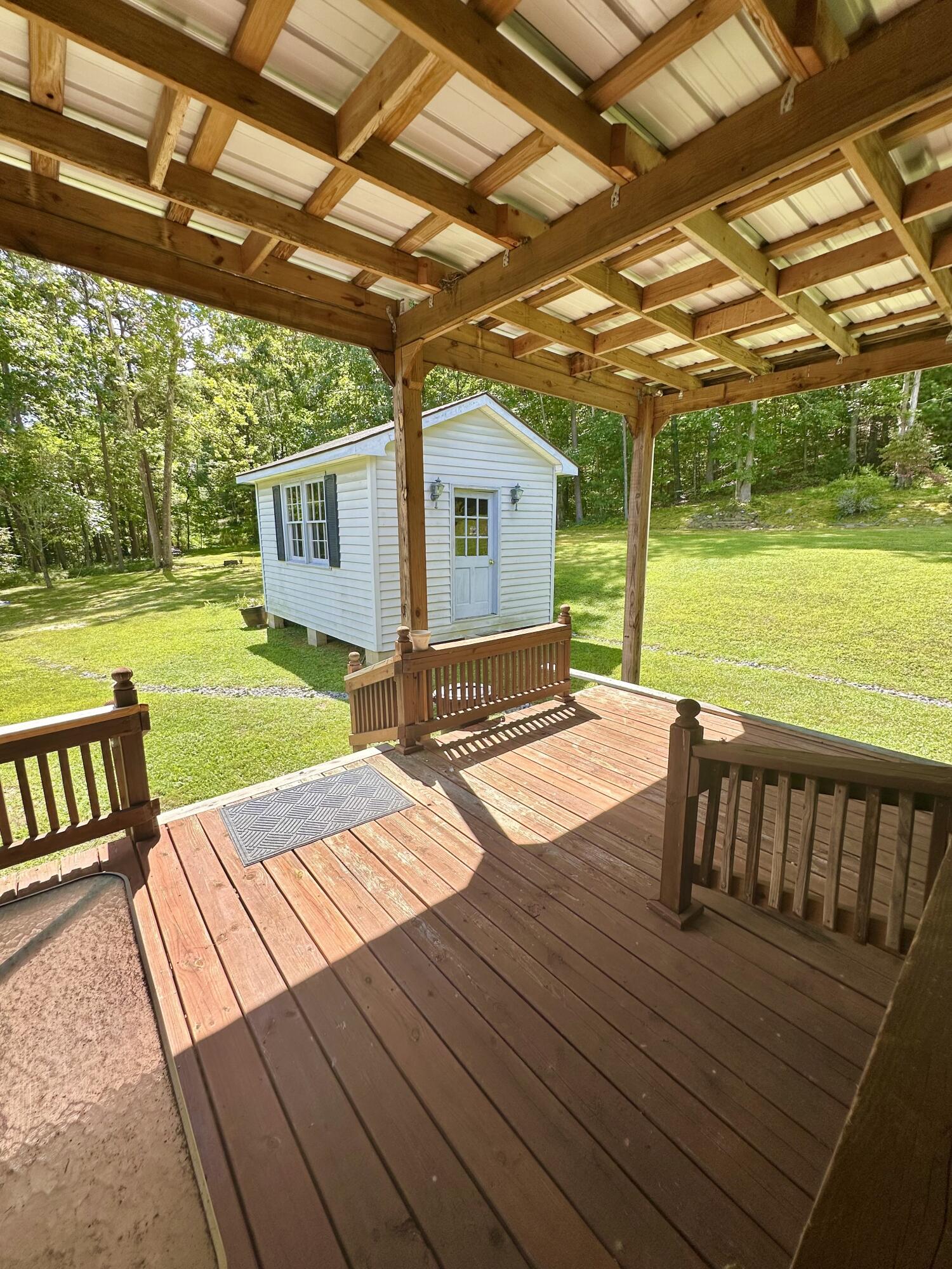 4801 Nicelytown Road Clifton Forge, VA 24422 - Photo 65 of 96 a view of a backyard with a table and chairs with wooden floor and fence