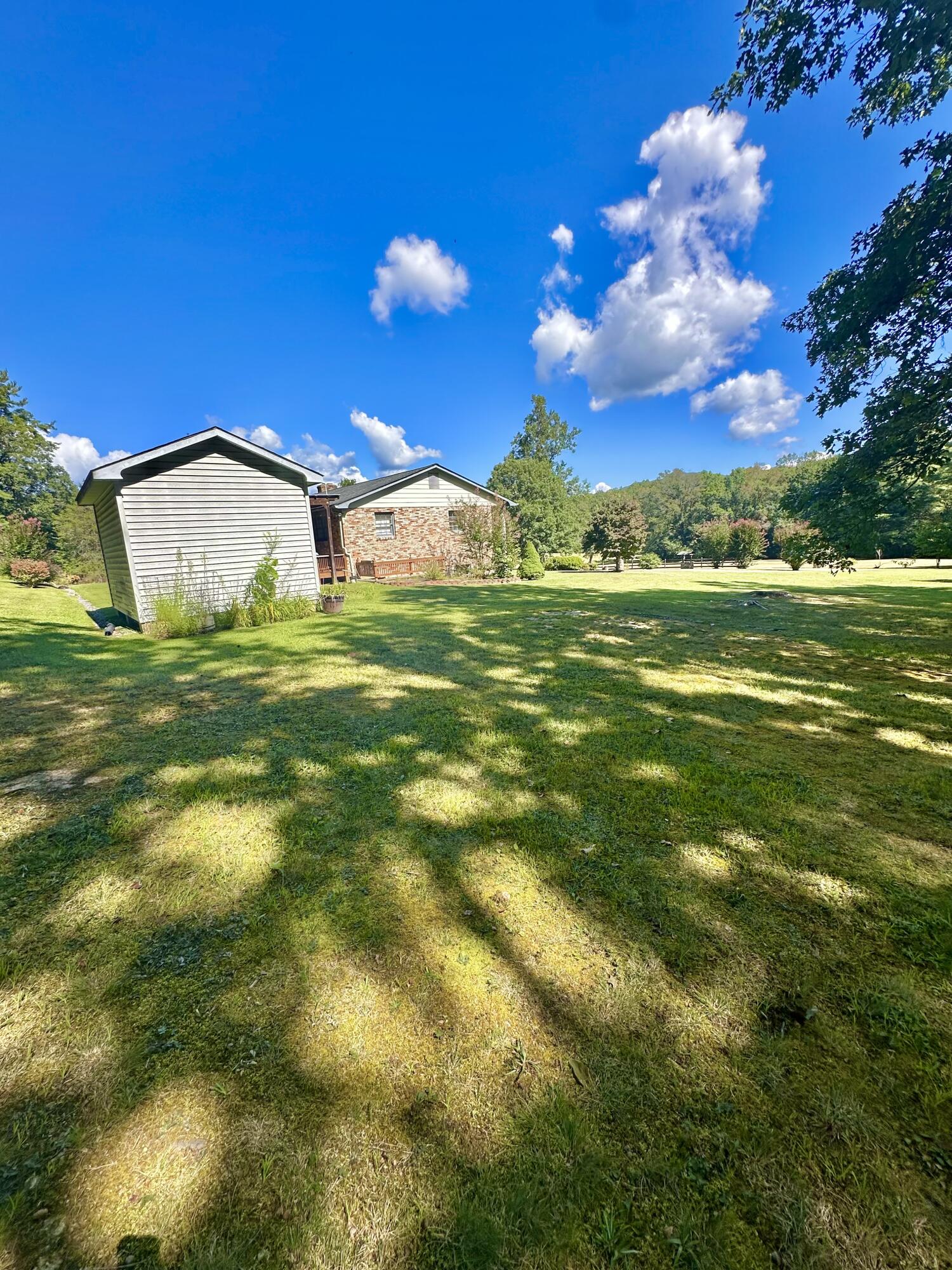 4801 Nicelytown Road Clifton Forge, VA 24422 - Photo 87 of 96 a view of a big yard with table and chairs and a fire pit with wooden fence