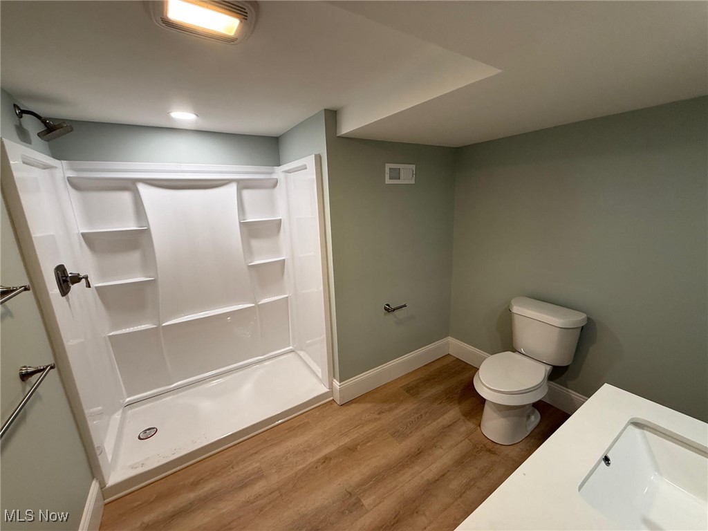 2185 Rexwood Road Cleveland, OH 44118 - Photo 15 of 26 Full bath featuring a shower stall, vanity, and light wood-style floors