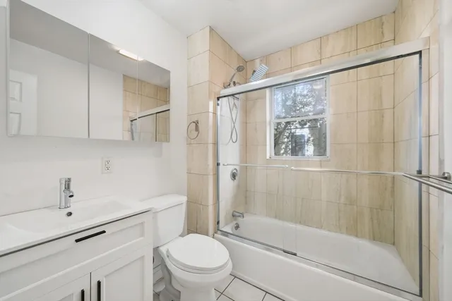 a bathroom with a shower a toilet and sink