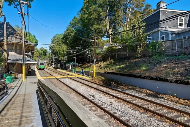 a view of a balcony with wooden floor and potted plants