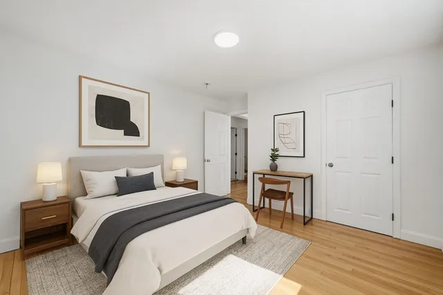 a bedroom with a bed and a chair