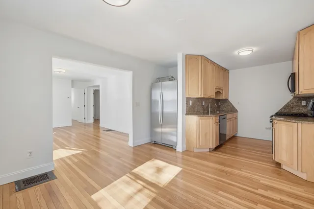 a kitchen with granite countertop a stove and a refrigerator