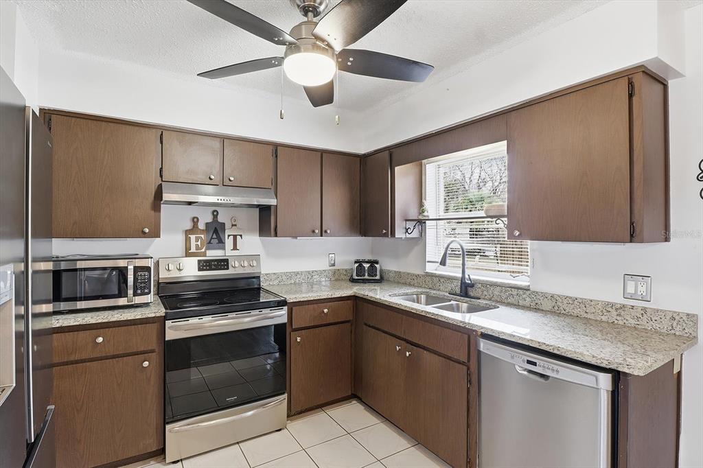 2341 South Whitier Point Homosassa, FL 34448 - Photo 14 of 36 a kitchen with a sink dishwasher a stove and a refrigerator with wooden floor