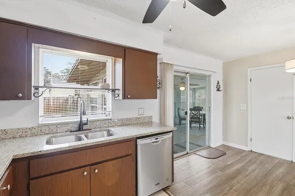 a kitchen with a sink cabinets and wooden floor