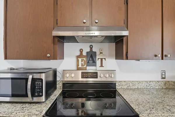 a stove top oven sitting inside of a kitchen