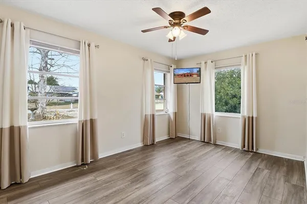 wooden floor in an empty room with a window