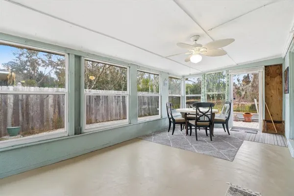 a dining room with furniture a chandelier and wooden floor