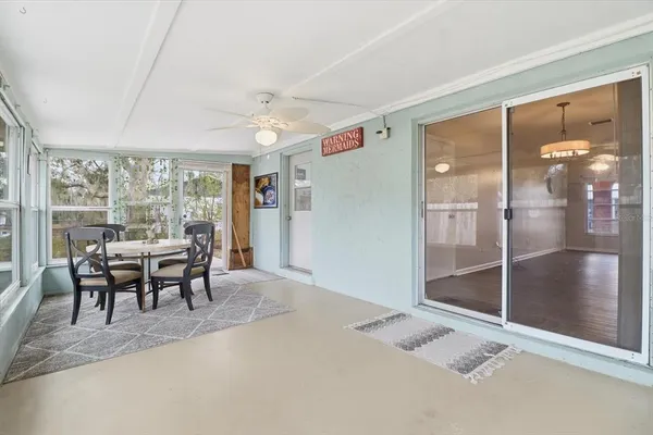 a dining room with furniture and a floor to ceiling window