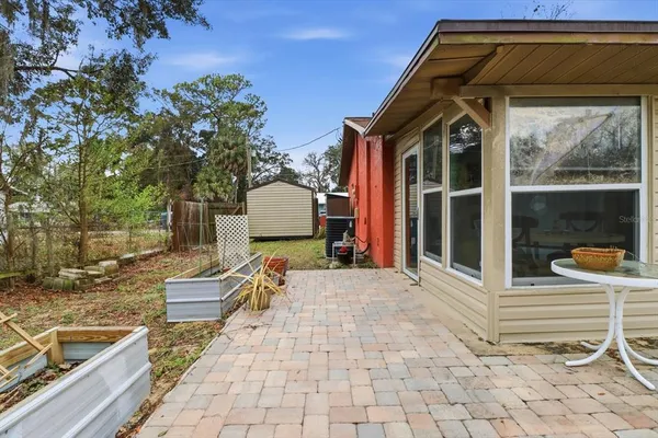 a view of a house with backyard and sitting area