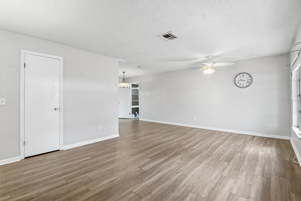 2341 South Whitier Point Homosassa, FL 34448 - Photo 7 of 36 an empty room with wooden floor and windows