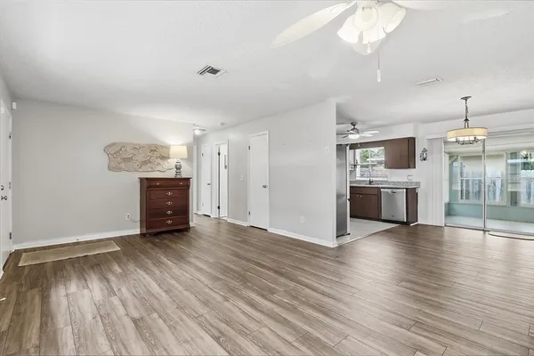 an empty room with wooden floor and fireplace