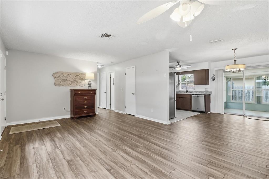 2341 South Whitier Point Homosassa, FL 34448 - Photo 8 of 36 an empty room with wooden floor and fireplace