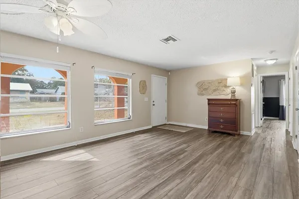 a view of a room with wooden floor and window