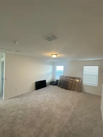 a large room with a bed and a window