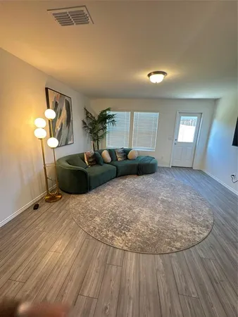 a view of a livingroom with furniture and wooden floor