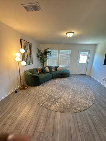 a view of a livingroom with furniture and wooden floor