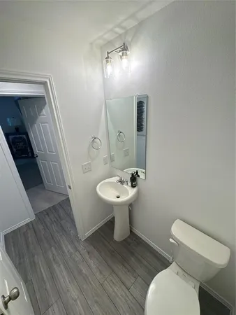 a bathroom with a sink toilet and mirror