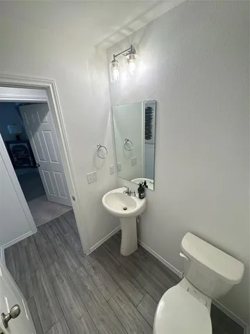 a bathroom with a sink toilet and mirror
