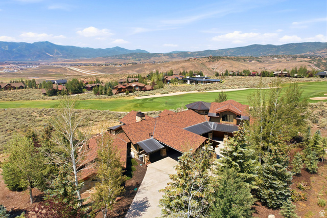 7885 North Rabbitbrush Court, Unit 13 Park City, UT 84098 - Photo 2 of 88 Expansive property featuring a multi-level roofline with natural stone and wood siding, surrounded by mature trees