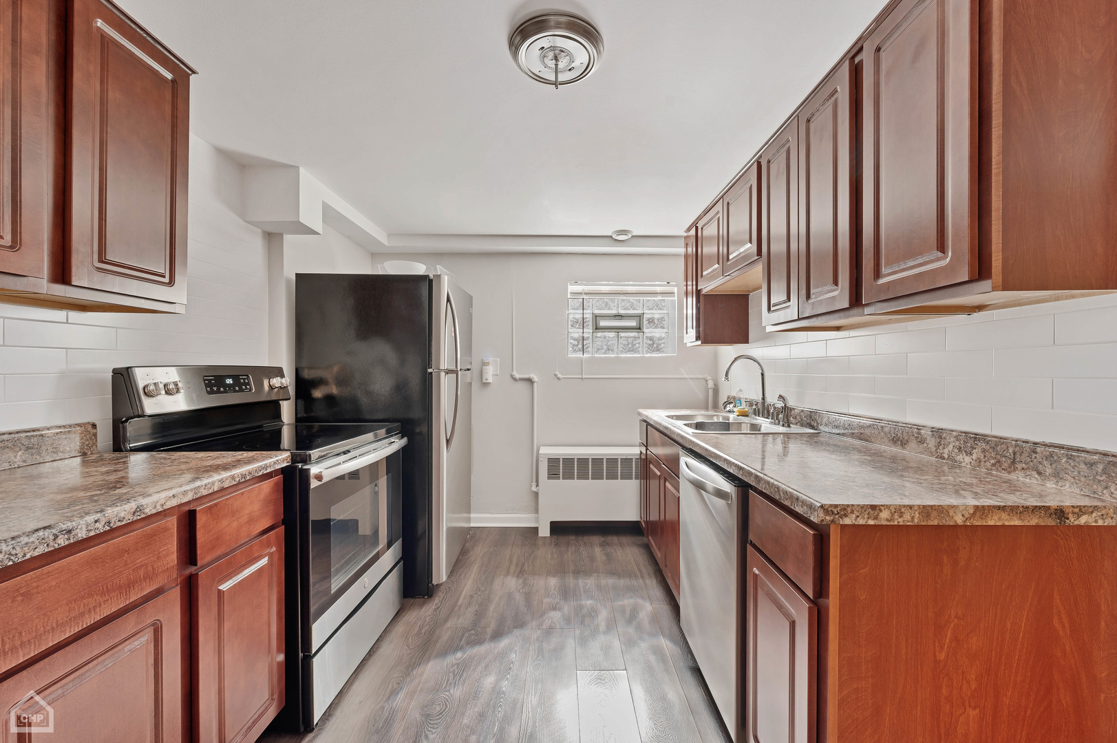 8912 Forestview Road Evanston, IL 60203 - Photo 11 of 31 a kitchen with granite countertop a sink stove and refrigerator