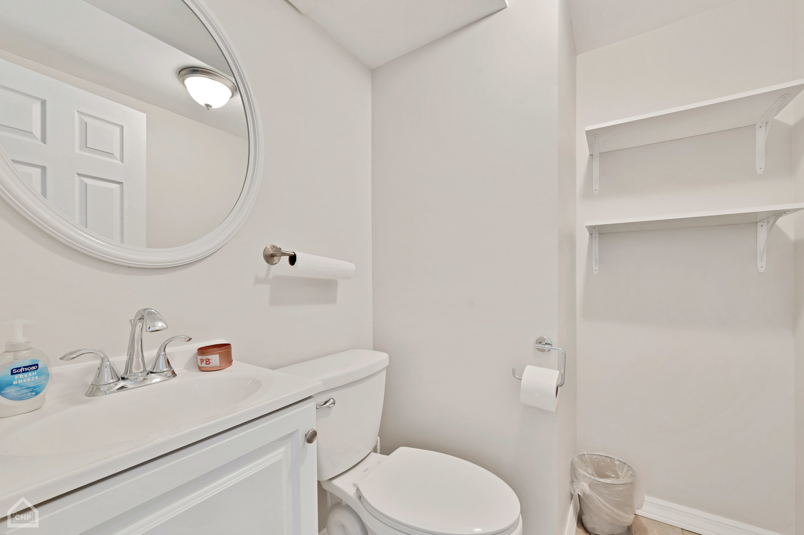 8912 Forestview Road Evanston, IL 60203 - Photo 14 of 31 a bathroom with a sink a toilet and a mirror