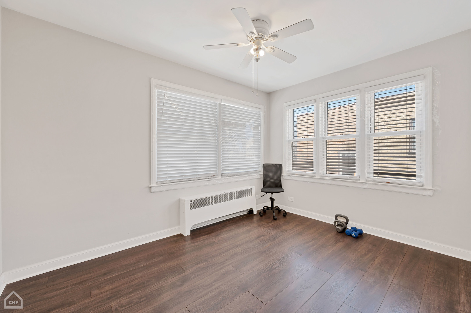 8912 Forestview Road Evanston, IL 60203 - Photo 23 of 31 a view of an empty room with a window and wooden floor