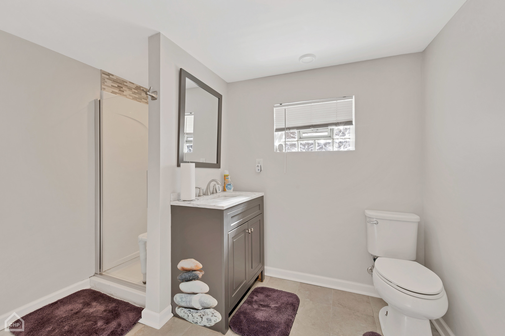 8912 Forestview Road Evanston, IL 60203 - Photo 24 of 31 a bathroom with a toilet a sink and mirror
