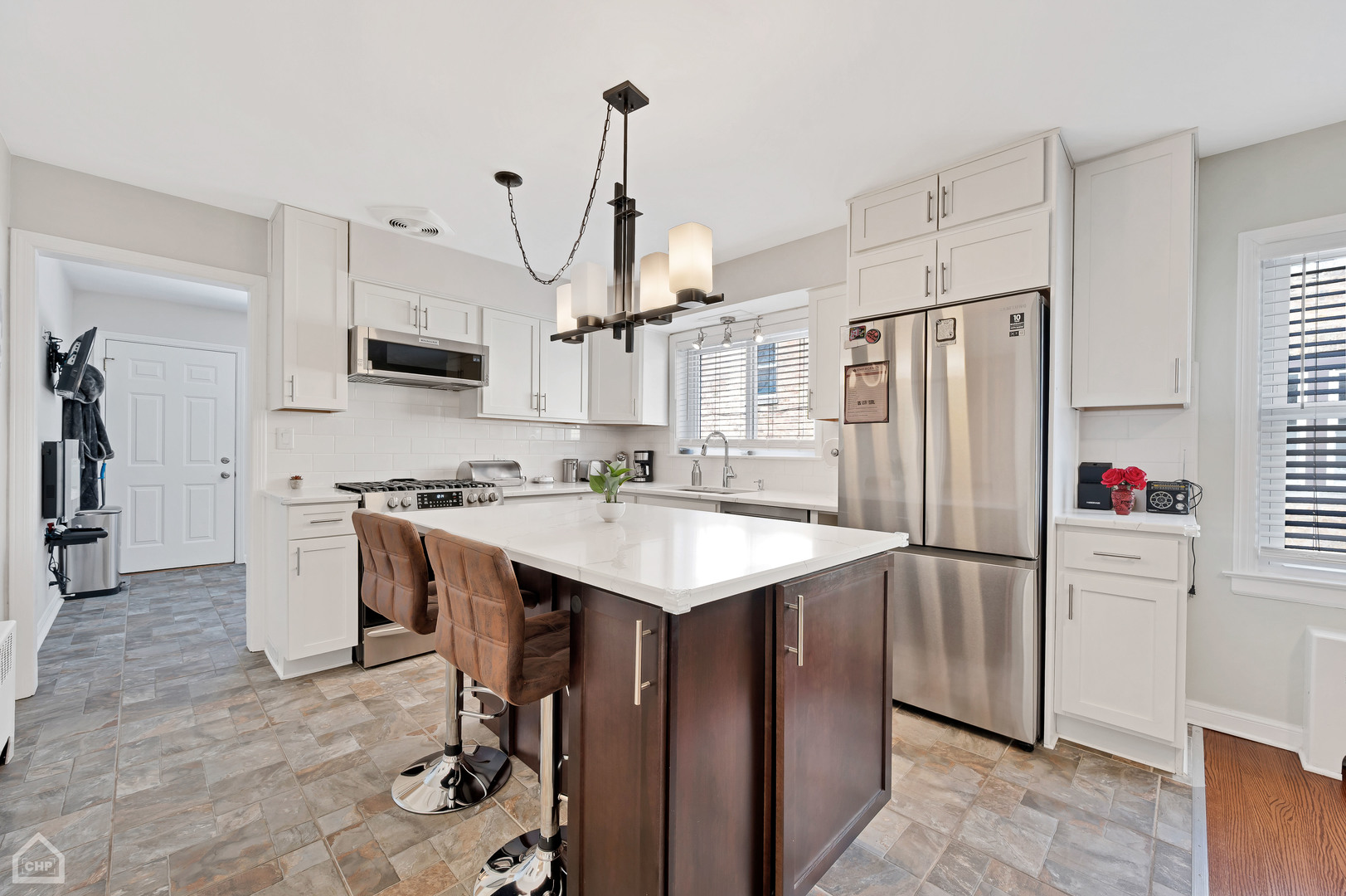 8912 Forestview Road Evanston, IL 60203 - Photo 5 of 31 a kitchen with refrigerator cabinets and a counter top