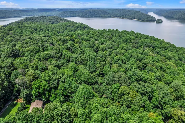 an aerial view of a houses with a yard