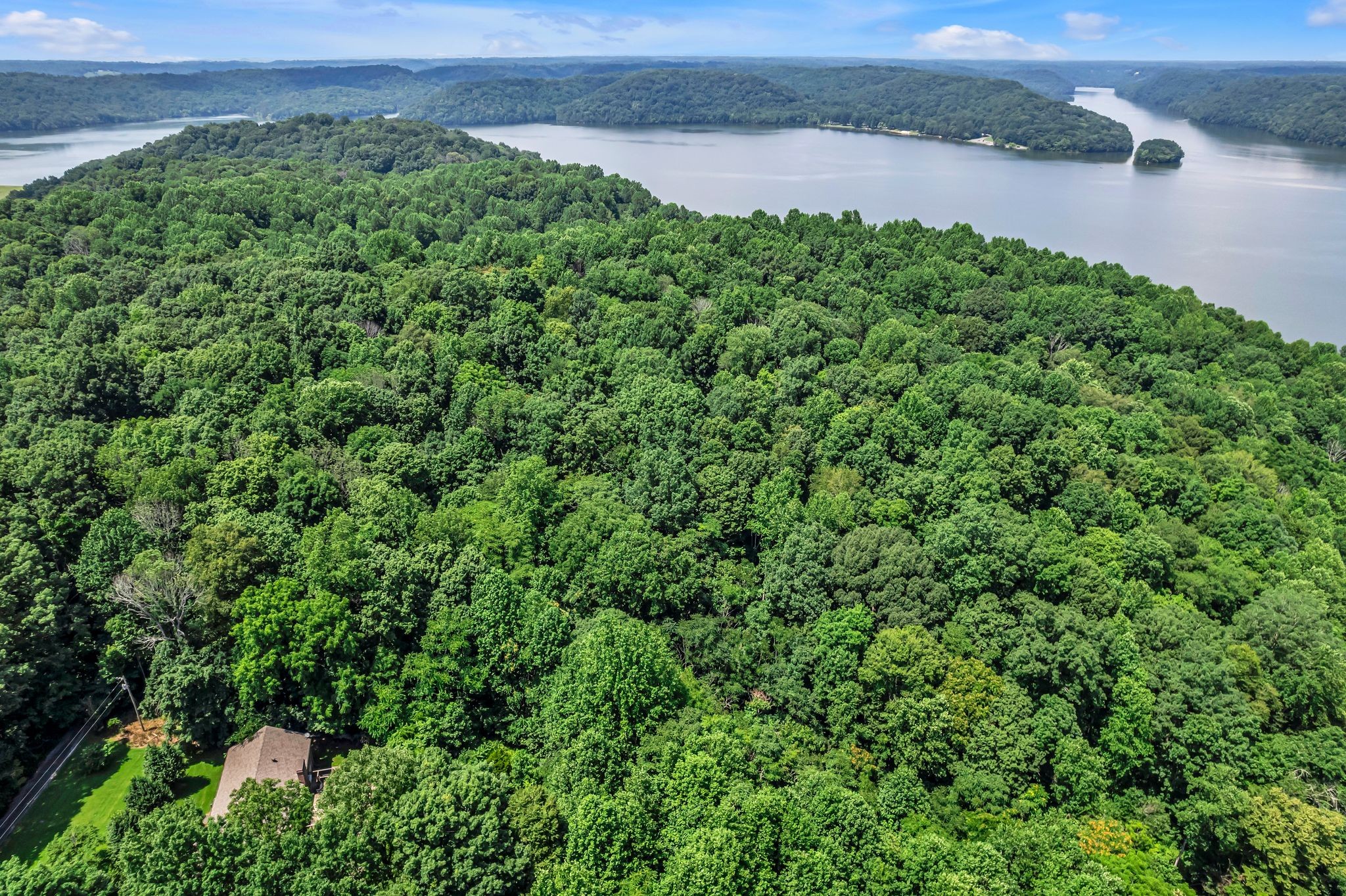 an aerial view of a houses with a yard