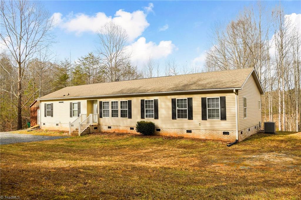 1591 Carson Road Pilot Mountain, NC 27041 - Photo 2 of 50 Recent architectural shingle roof with storage building to the left of the home