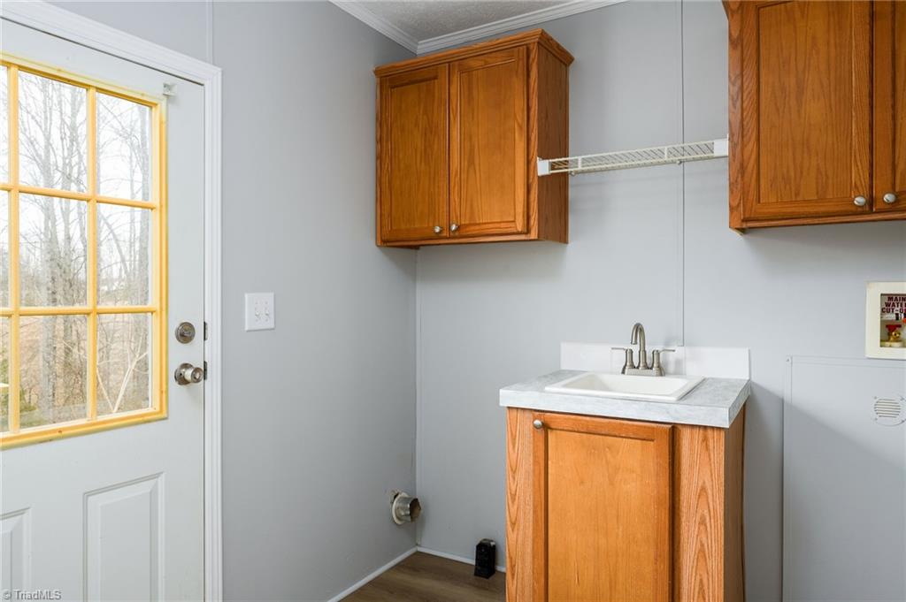 1591 Carson Road Pilot Mountain, NC 27041 - Photo 39 of 50 Laundry room has built in cabinets, mud sink, and pantry