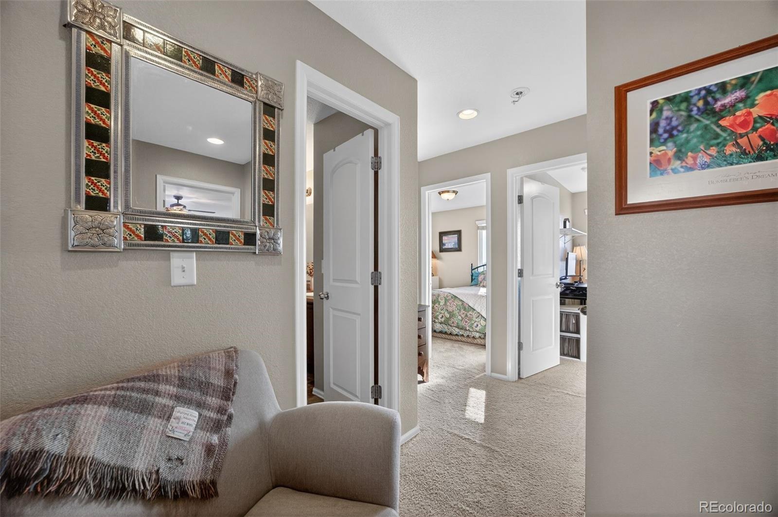 10247 Olathe Way Commerce City, CO 80022 - Photo 16 of 37 a living room with furniture and a painting on the wall