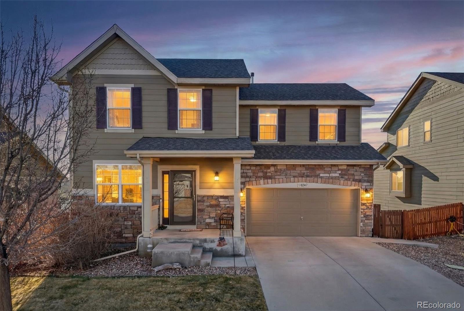 10247 Olathe Way Commerce City, CO 80022 - Photo 2 of 37 a front view of a house with garden