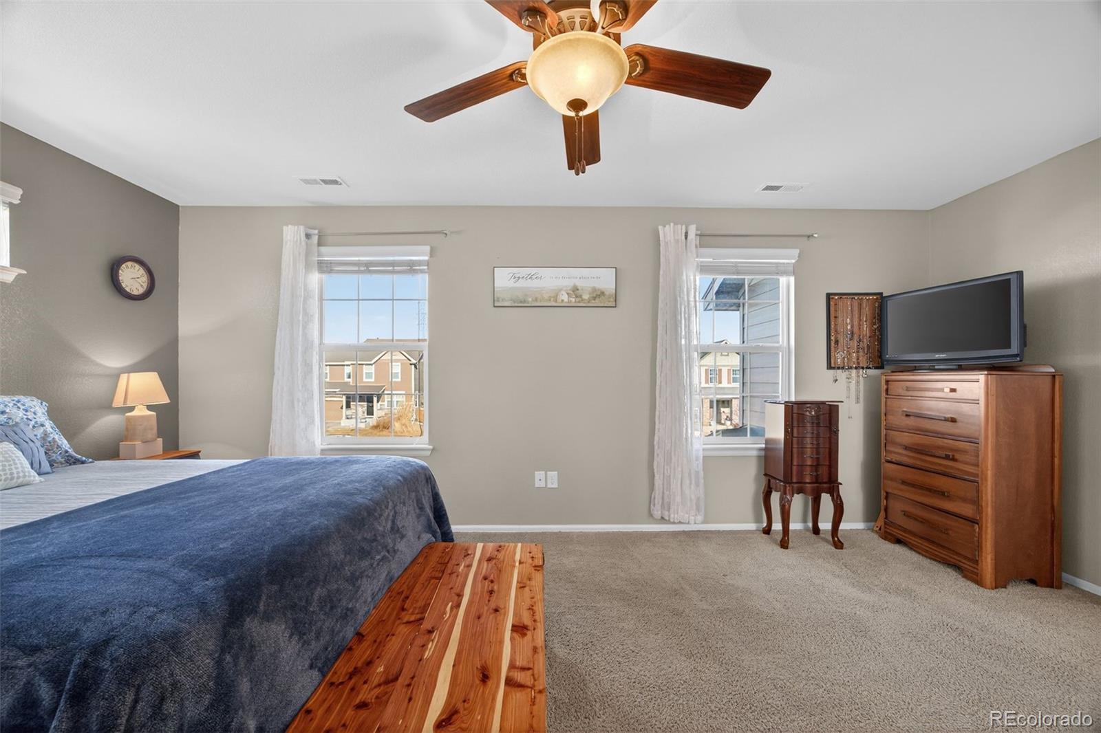 10247 Olathe Way Commerce City, CO 80022 - Photo 26 of 37 a bedroom with a bed and a flat tv screen