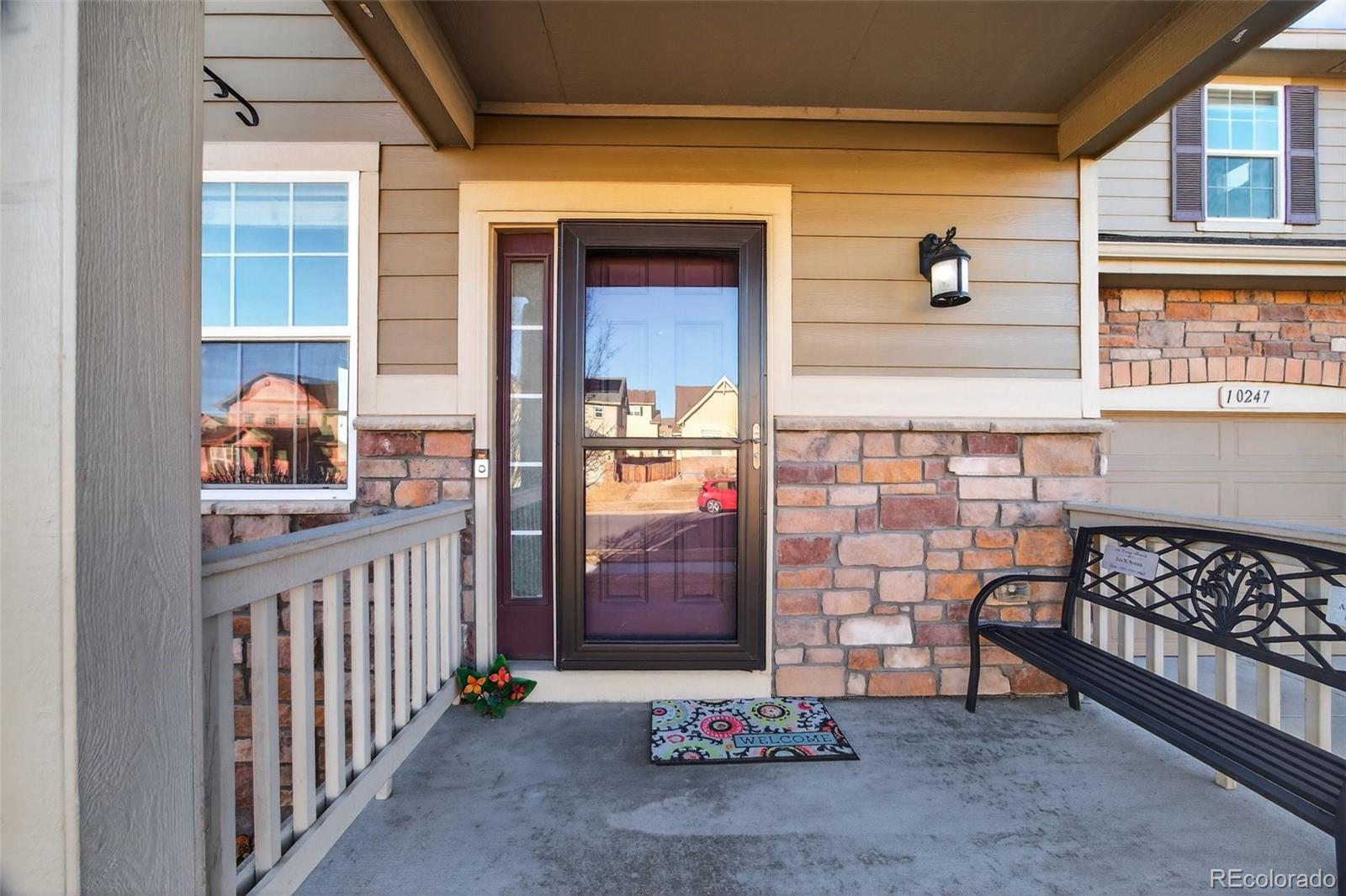 10247 Olathe Way Commerce City, CO 80022 - Photo 3 of 37 a view of a porch with a table and chairs