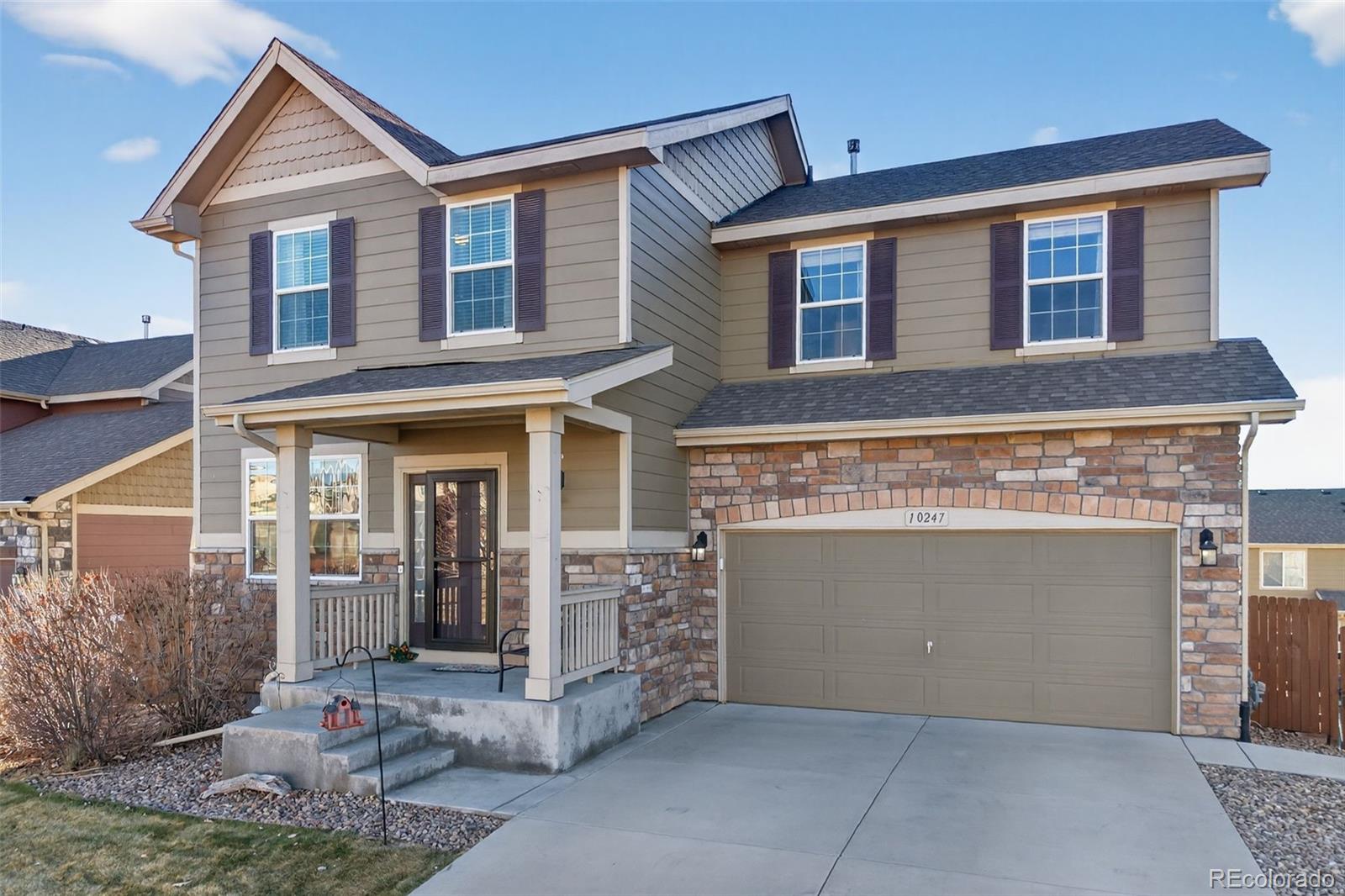 10247 Olathe Way Commerce City, CO 80022 - Photo 4 of 37 a front view of a house with a garage
