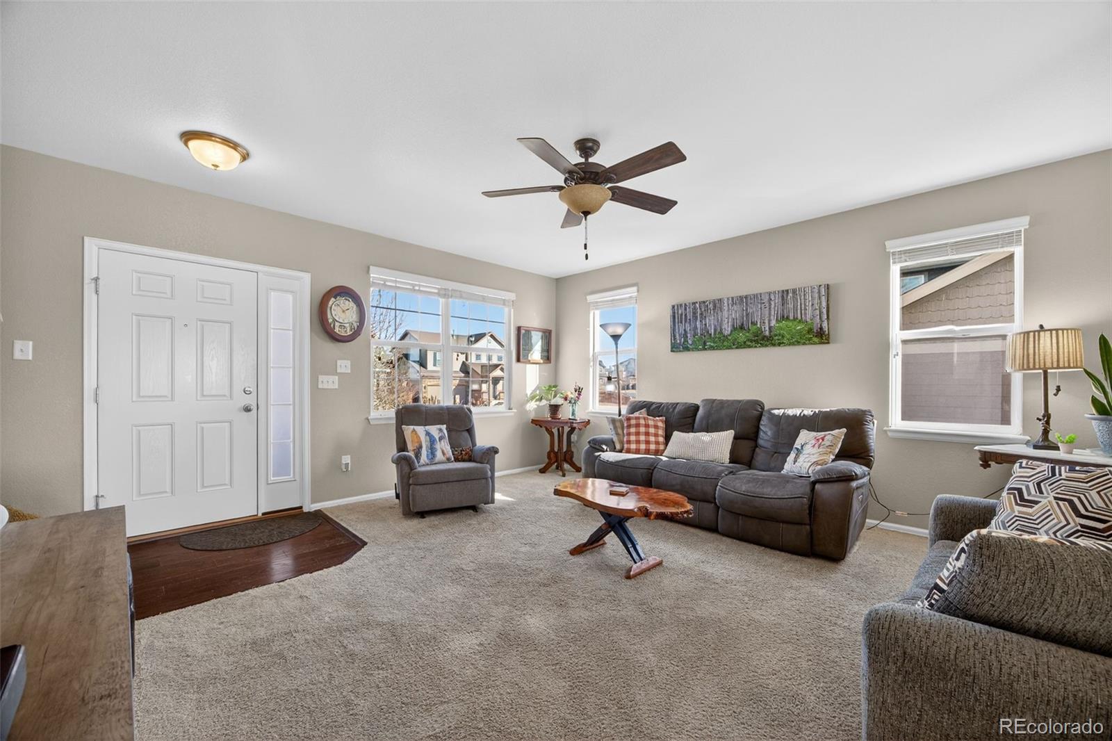 10247 Olathe Way Commerce City, CO 80022 - Photo 7 of 37 a living room with furniture and a window