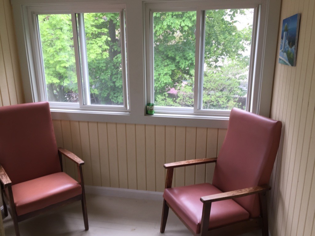 a view of a room with a chair and windows
