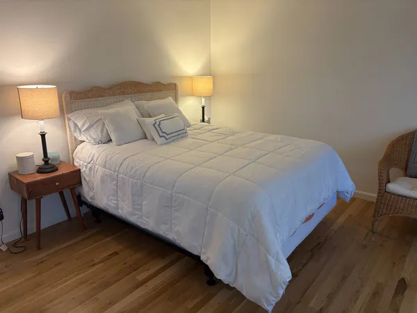 a bedroom with a bed and a lamp