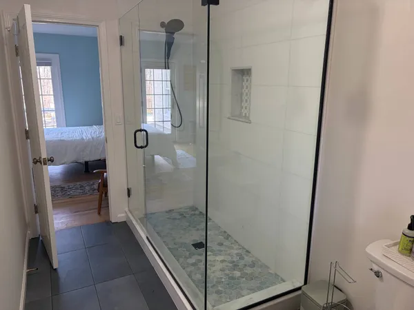 a bathroom with a glass shower door