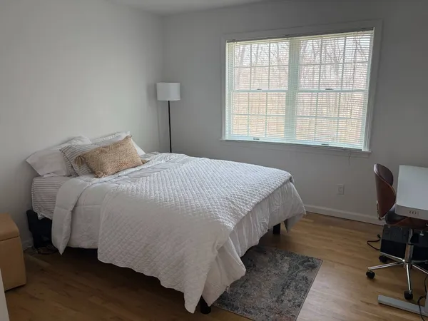 a bedroom with a bed lamps and window