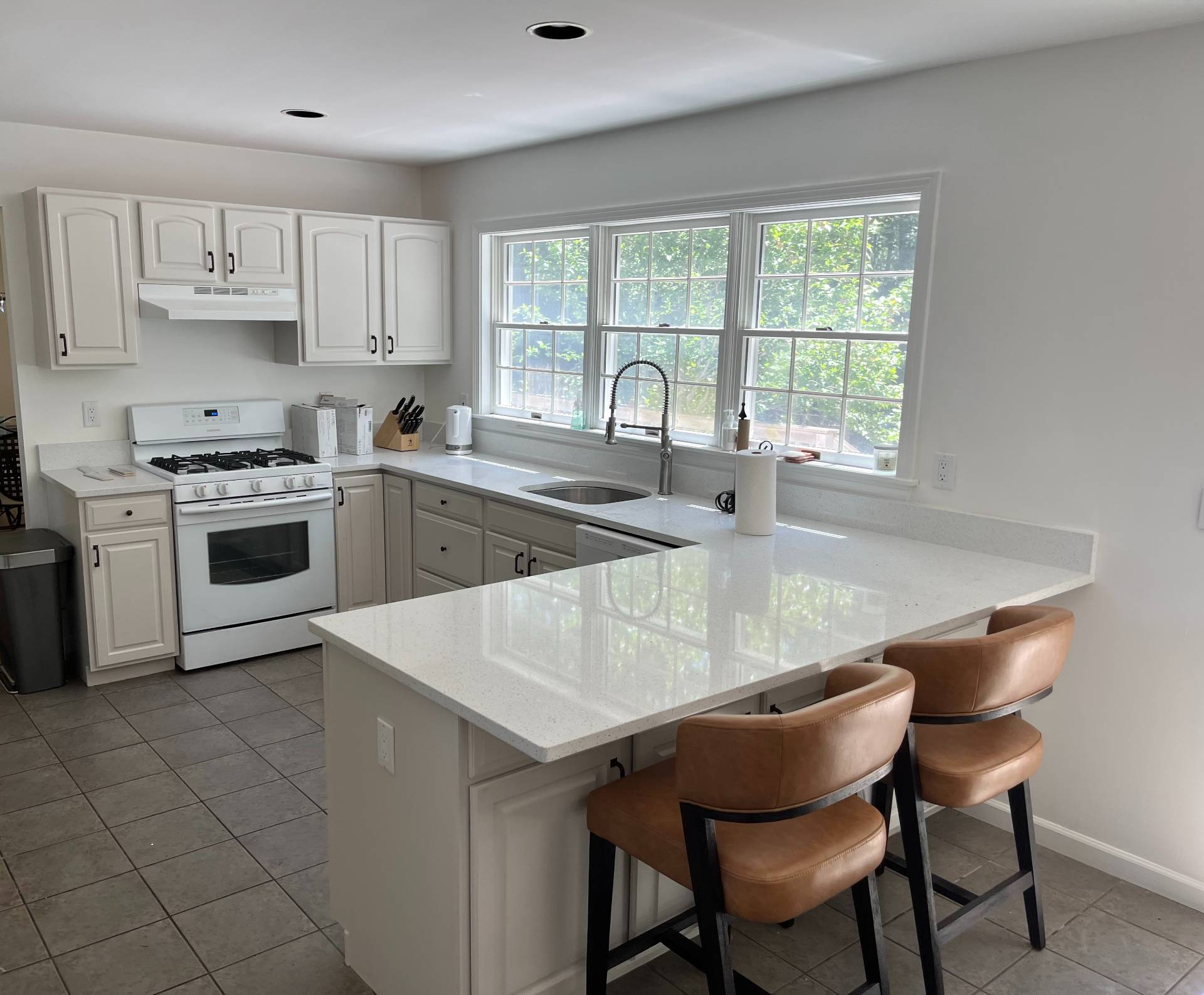 48 Tansey Lane Bridgehampton, NY 11932 - Photo 6 of 15 a kitchen with stainless steel appliances granite countertop a stove a sink a microwave and a refrigerator